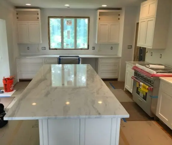 White stone kitchen island in a completed renovation.