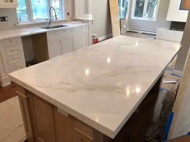 White stone island installed in a new kitchen.