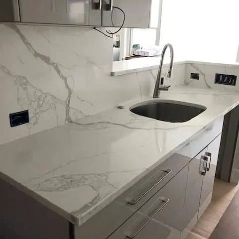 Veined stone countertop with a kitchen undermount sink.