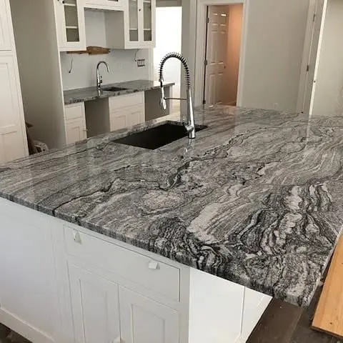 Gray veined stone countertop on a kitchen island.