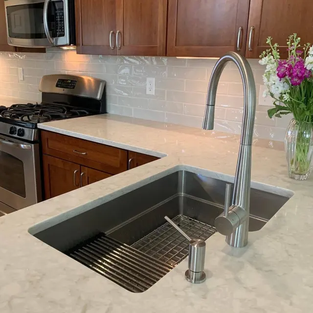 Stone kitchen countertop with an undermount sink.