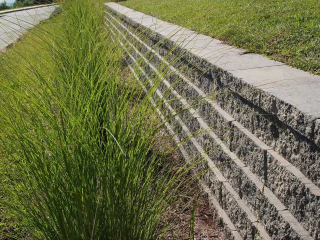 Stone retaining wall at a home exterior.