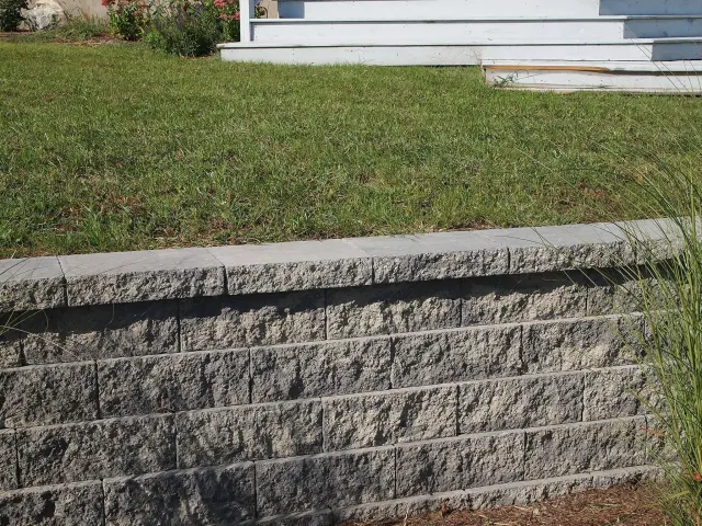 Low stone wall in a residential landscape.