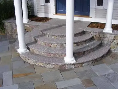 Stone porch steps at a home entry.