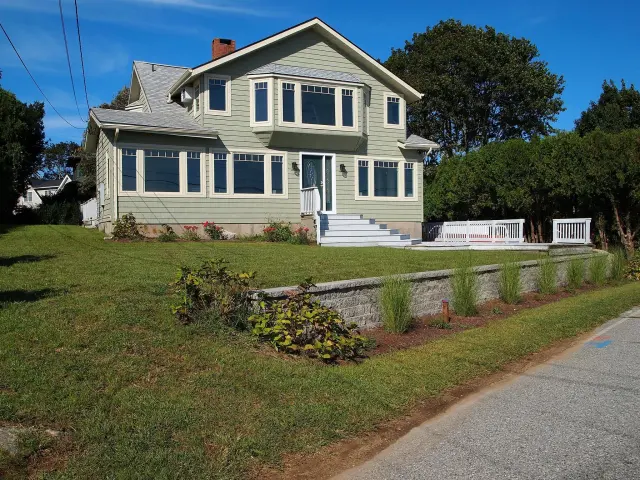Stone hardscape around a completed home exterior.