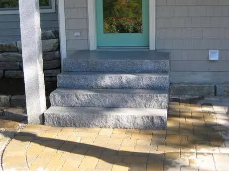 Natural stone entry steps at a finished home.