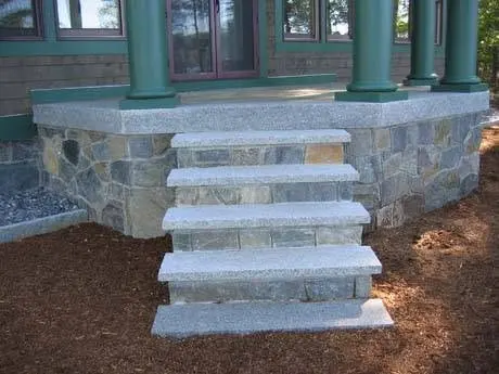 Stone front entry steps at a home.