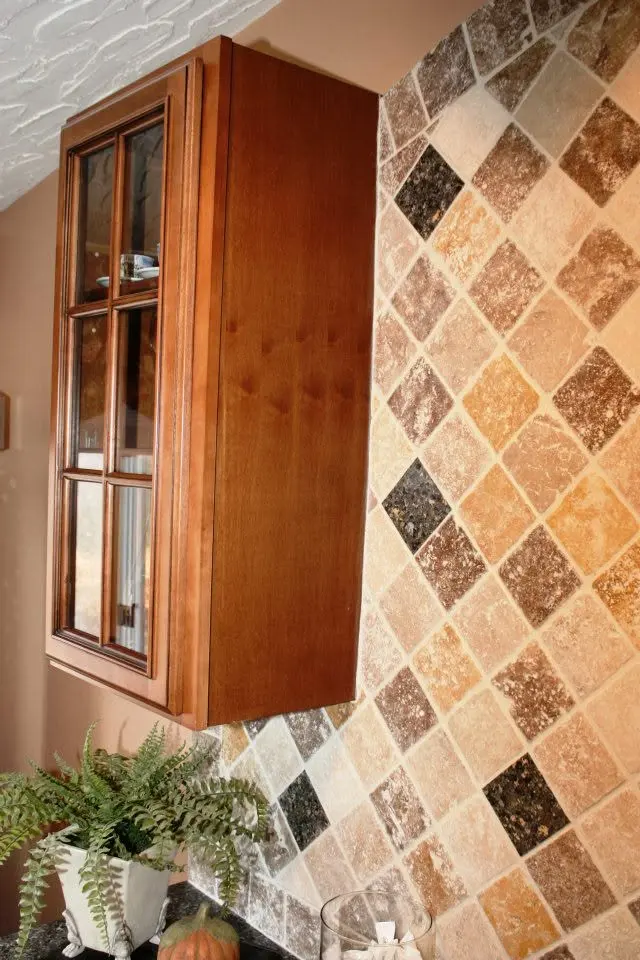 Warm-toned tile backsplash in a kitchen.