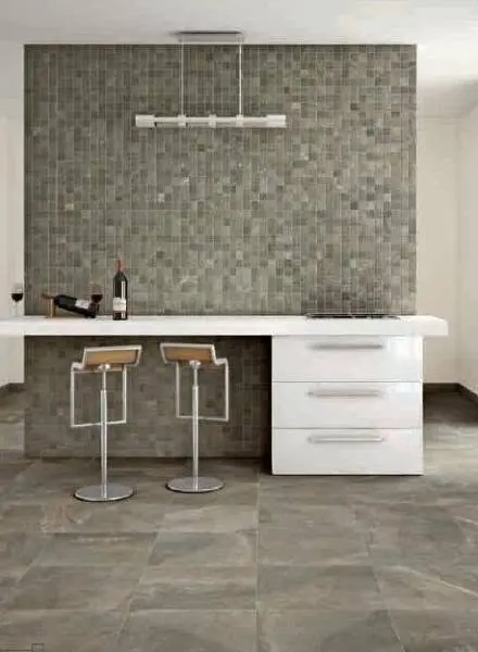 Gray mosaic tile feature wall in a kitchen setting.