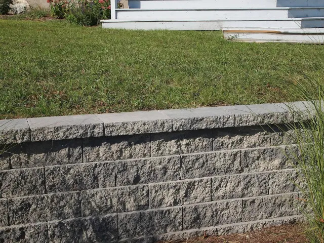 Low stone wall in a residential landscape.