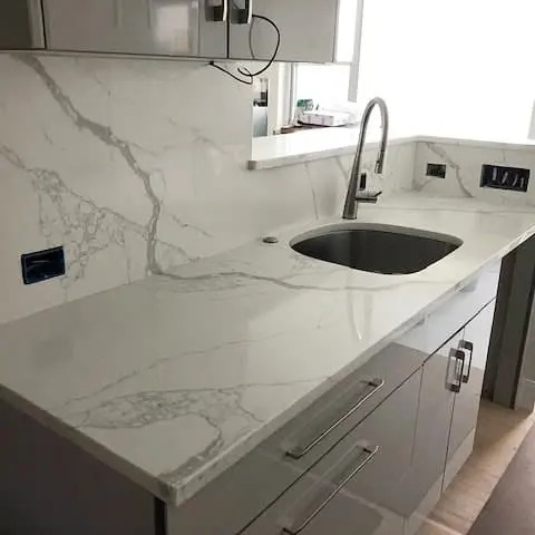 Veined stone countertop with a kitchen undermount sink.
