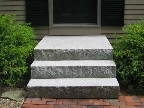 Granite front steps at a completed home entrance.