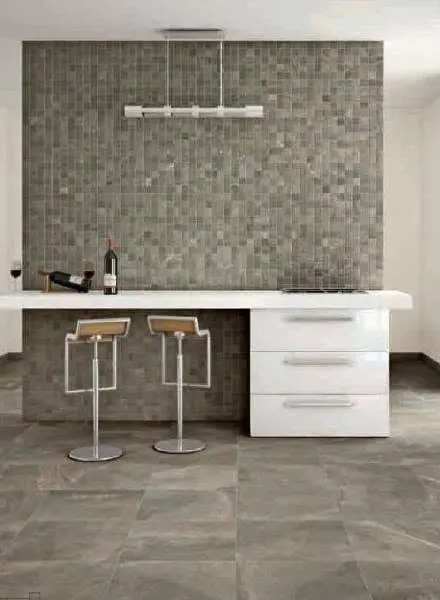 Gray mosaic tile feature wall in a kitchen setting.