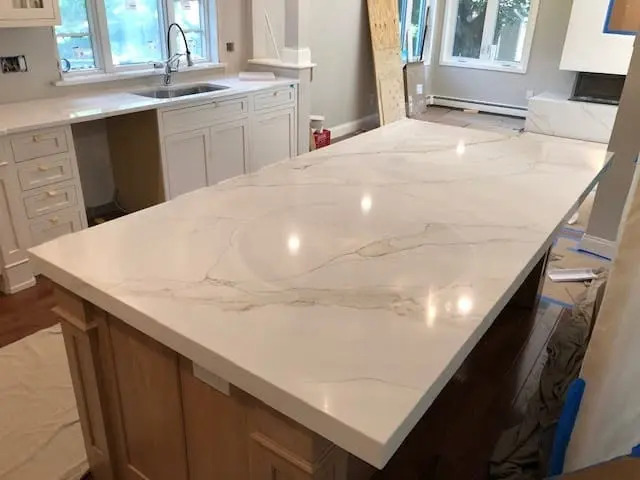White stone island installed in a new kitchen.