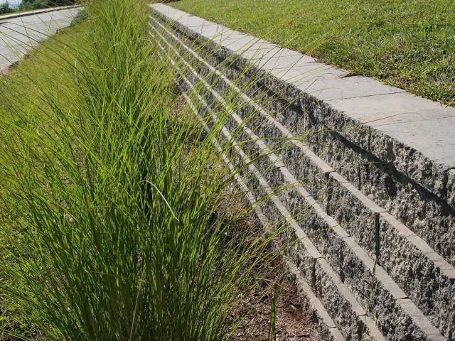 Stone retaining wall at a home exterior.